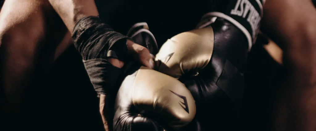 Close-up photograph of the boxing gloves of a fighter taking a break from training